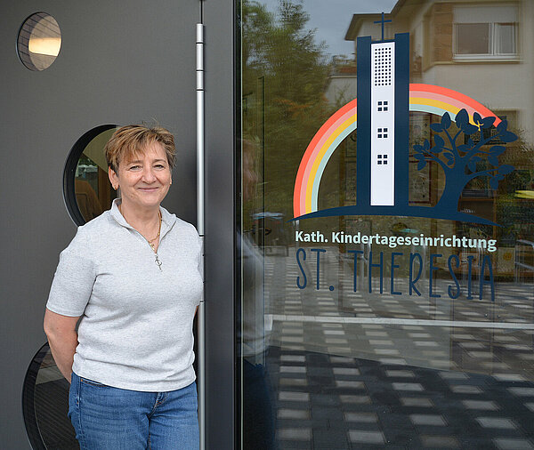 Porträt KiTa-Leiterin Claudia Hose vor KiTa-Eingang